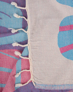 Close-up of a fabric with colorful patterns and frayed edges.
