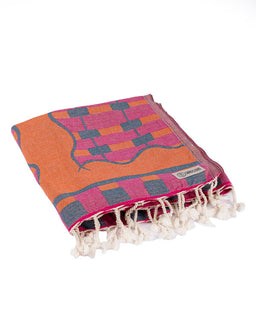 Colorful towel with geometric pattern and tassels on a white background