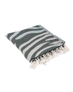 Gray and white striped towel with tassels on a white background