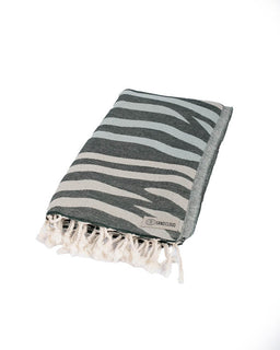 Striped towel with tassels on a white background