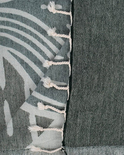 Close-up of a fabric with white stitching and abstract pattern
