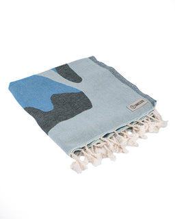 Blue and gray patterned towel with tassels on a white background