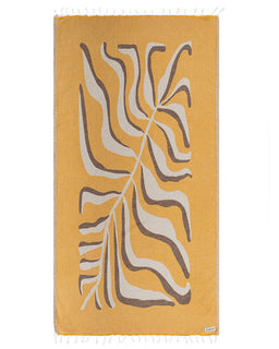 Yellow towel with leaf pattern on a white background