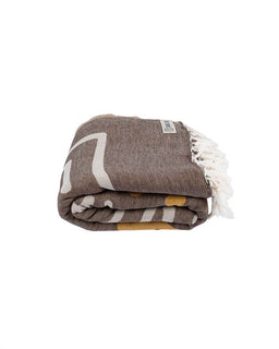 Folded towel with white fringe on a white background