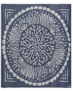 Blue and white mandala patterned towel with fringe on a white background
