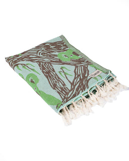 Folded towel with animal pattern and tassels on a white background