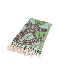 folded towel with tree pattern and tassels on a white background