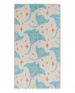 Towel with blue and green devil rays pattern on a beige background