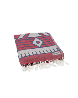 Red and gray patterned towel with white tassels on a white background