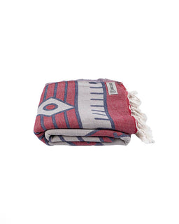 Folded towel with red, gray, and blue pattern on a white background