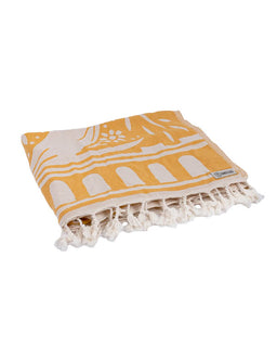Yellow towel with white patterns and fringes on a white background