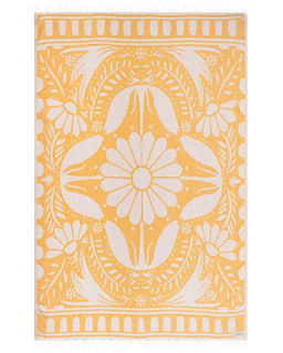 Yellow towel with white floral pattern on a white background