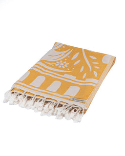 Yellow towel with white patterns and fringes on a white background