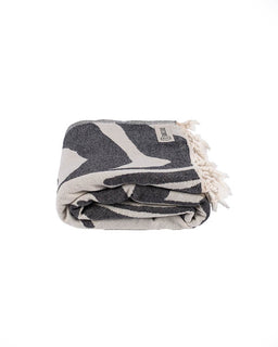 Folded towel with geometric pattern on a white background