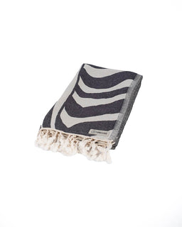 Zebra patterned towel with lace trim on a white background