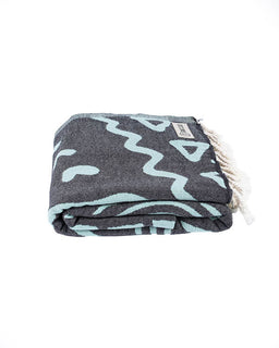 Folded towel with wavy pattern on a white background