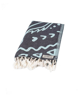 Black towel with light blue abstract patterns and fringes on a white background