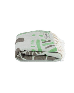 Folded blanket with green and brown patterns on a white background