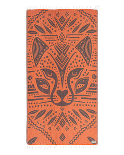 Orange towel with a black geometric pattern of a cheetah face on a white background