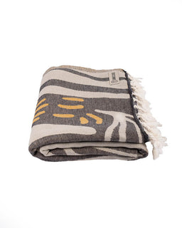 Folded towel with abstract patterns on a white background
