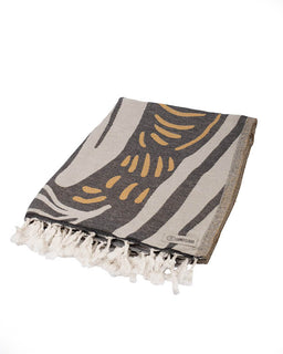 Textile with abstract pattern and tassels on a white background