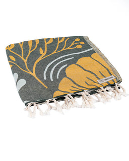 Gray and yellow patterned towel with tassels on a white background