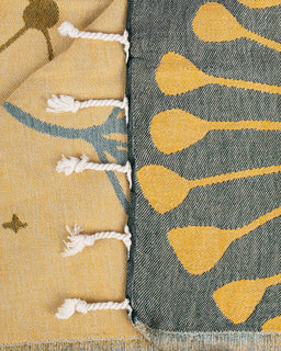 Close-up of two patterned towel with geometric designs on a neutral background