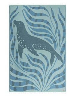 Towel with a sea lion design surrounded by wavy patterns on a blue background