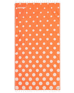 coral towel with white polka dots on a white background