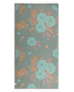 Floral patterned rug with teal and orange flowers on a gray background