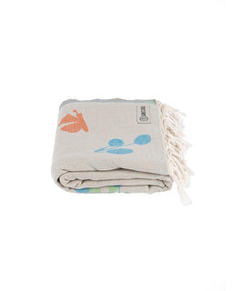 Folded towel with colorful designs and fringes on a white background