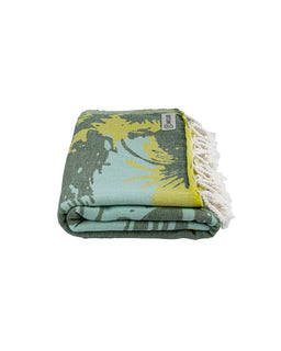 Folded towel with palm tree design on a white background