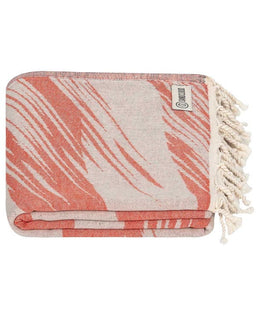 Coral and beige patterned towel with tassels on a white background