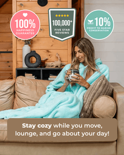 A woman lounges on a tan sofa wrapped in a fluffy light aqua blanket, holding a mug in a cozy living room. Three promotional badges appear at the top, and a text banner at the bottom reads, 'Stay cozy while you move, lounge, and go about your day!'.